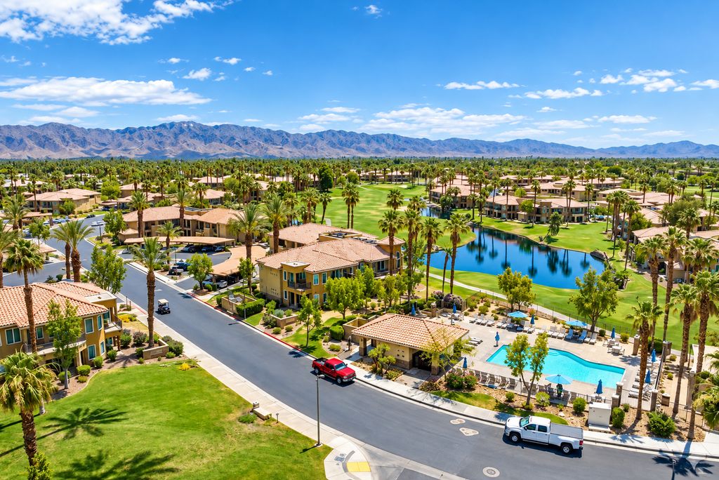 Homes, palms, golf landscape and mountain backdrop